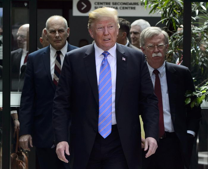 US President Donald Trump and his own National Security Advisor, John Bolton, and economist Peter Navarro